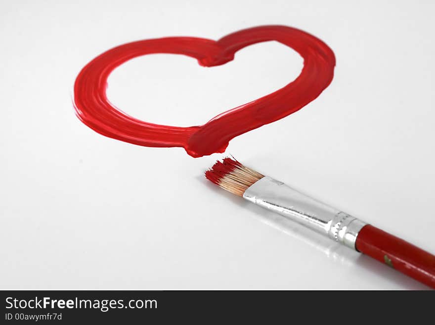 A red painted heart with paintbrush on white. A red painted heart with paintbrush on white