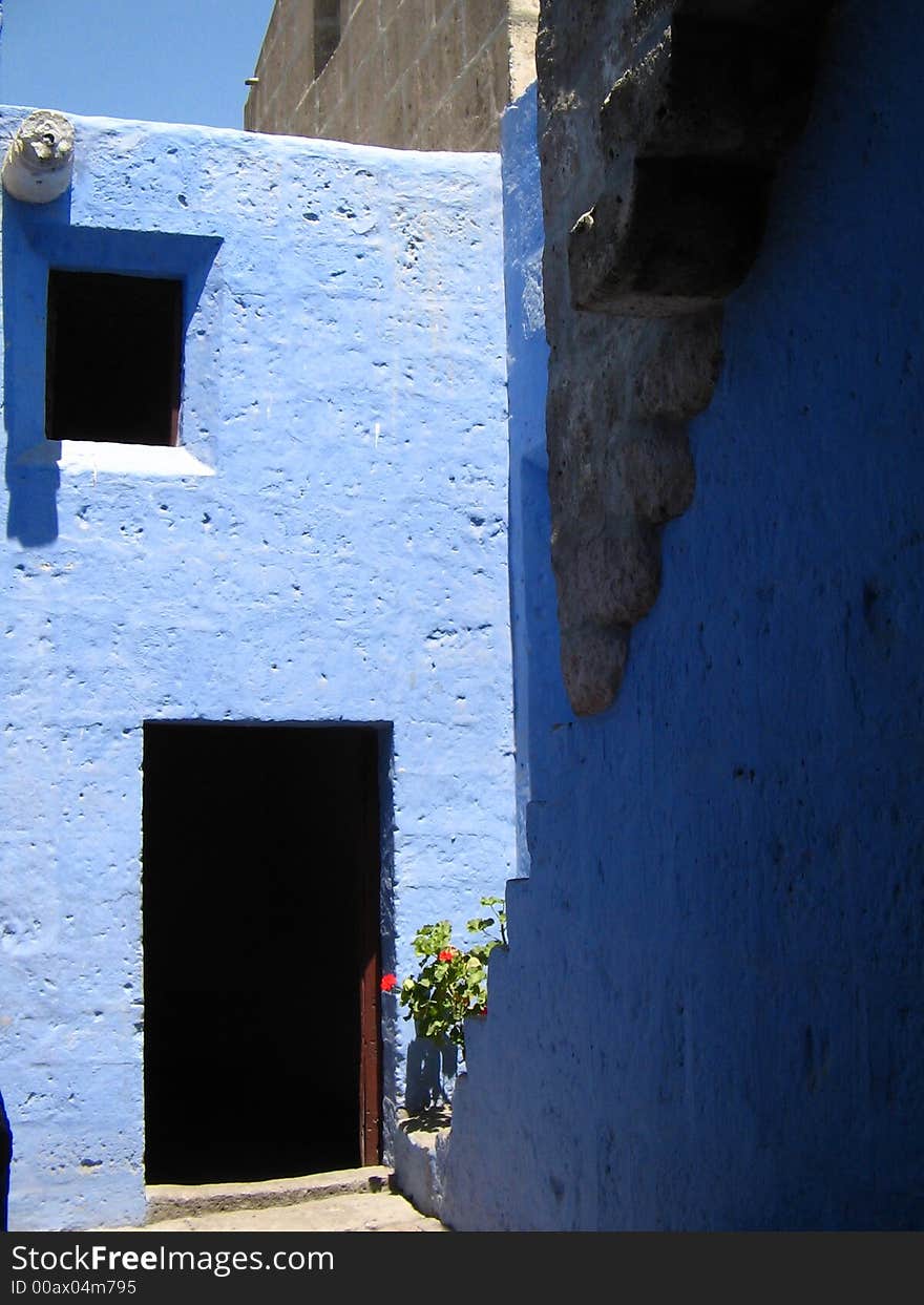 Open wooden door with steps against blue walls, arequipa, peru. Open wooden door with steps against blue walls, arequipa, peru