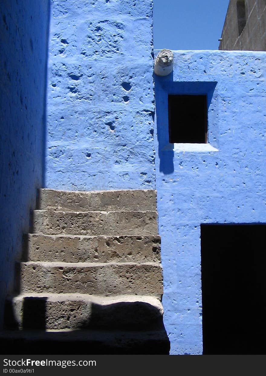 Open wooden door with steps against blue walls, arequipa, peru. Open wooden door with steps against blue walls, arequipa, peru