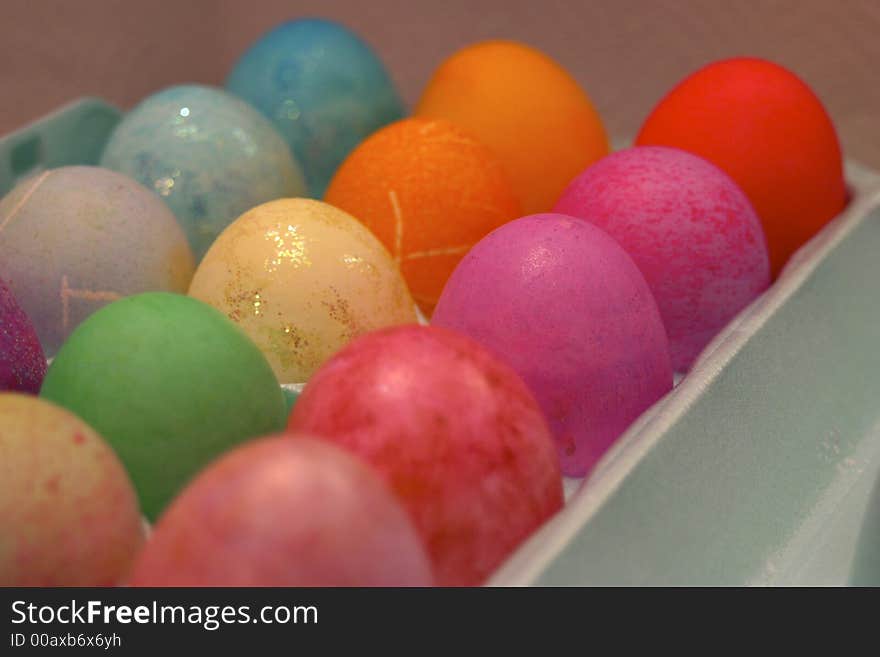 Colorful Easter eggs sit in an egg tray after being dyed. Colorful Easter eggs sit in an egg tray after being dyed