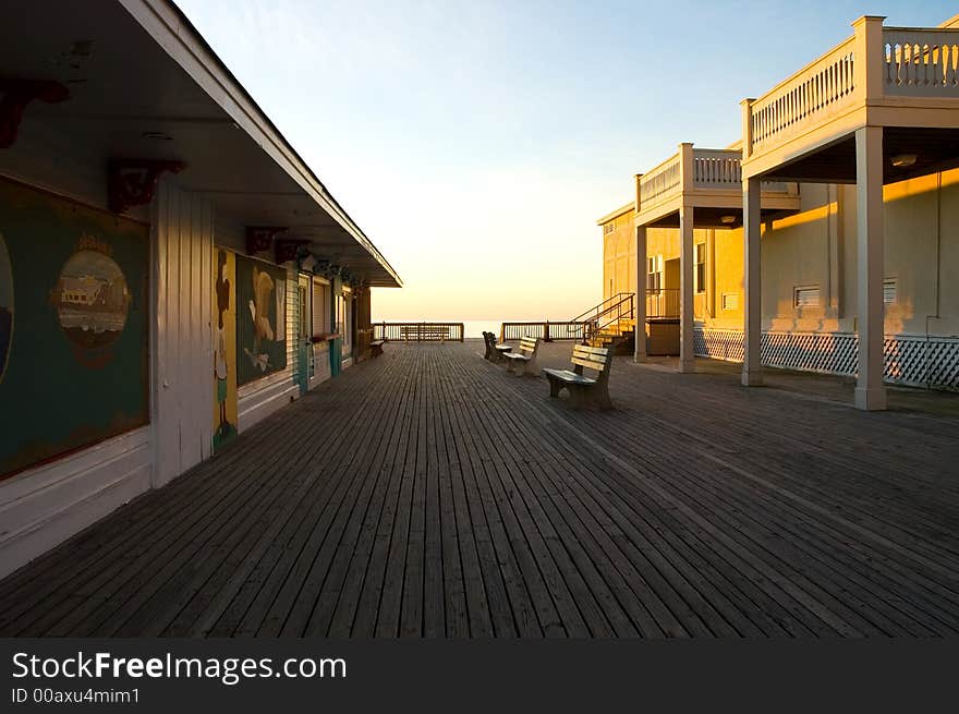 The sun rises on a new day and a deserted boardwalk at a popular Atlantic resort beach.  The shops are closed and all is quiet, but not for long. The sun rises on a new day and a deserted boardwalk at a popular Atlantic resort beach.  The shops are closed and all is quiet, but not for long...