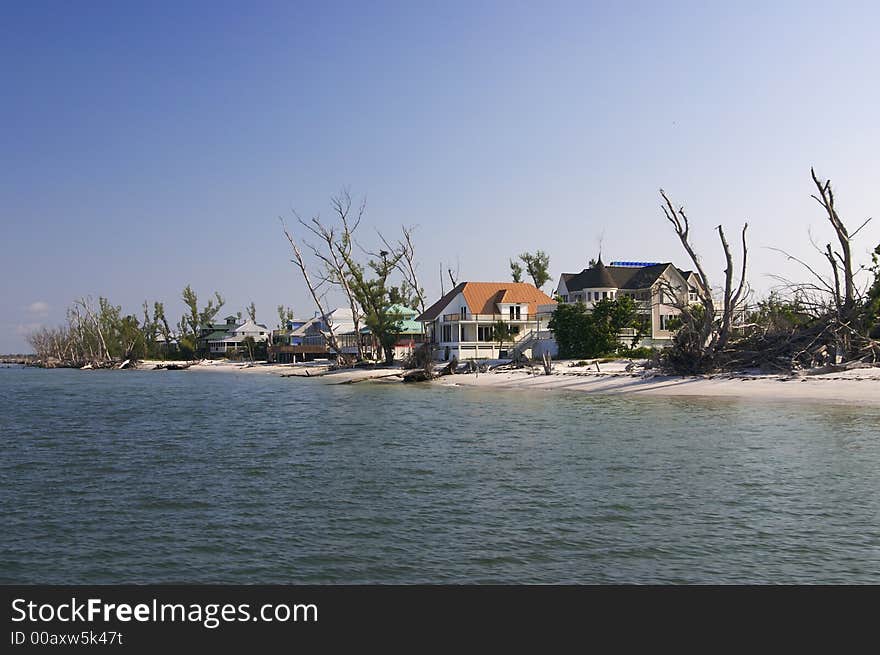 Tropical beach setting with a beautiful Florida style homes - shows storm damage from hurricane Charlie. Tropical beach setting with a beautiful Florida style homes - shows storm damage from hurricane Charlie