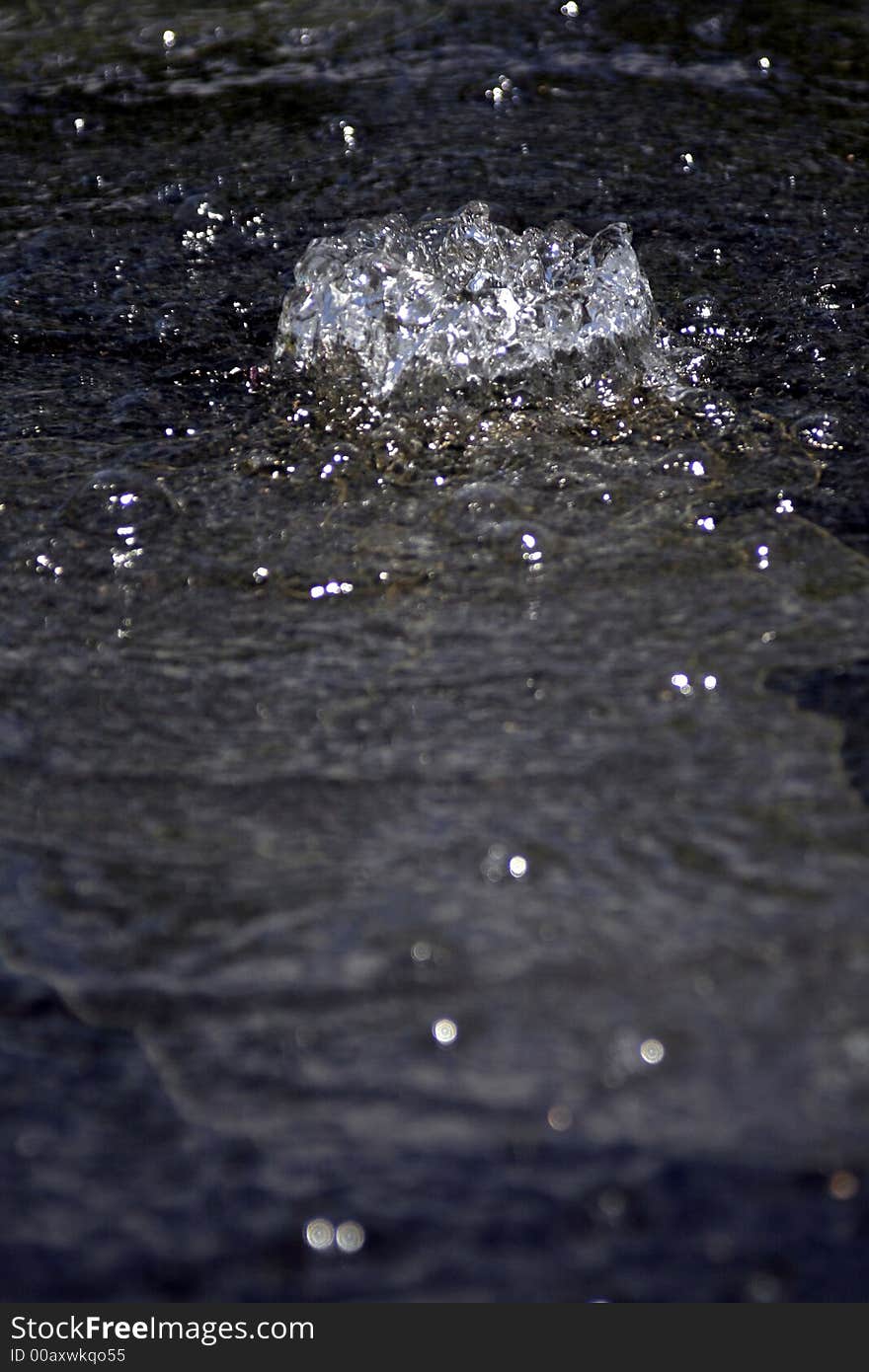 Flat Water Surface On Black Stone With Fountain Source, Background