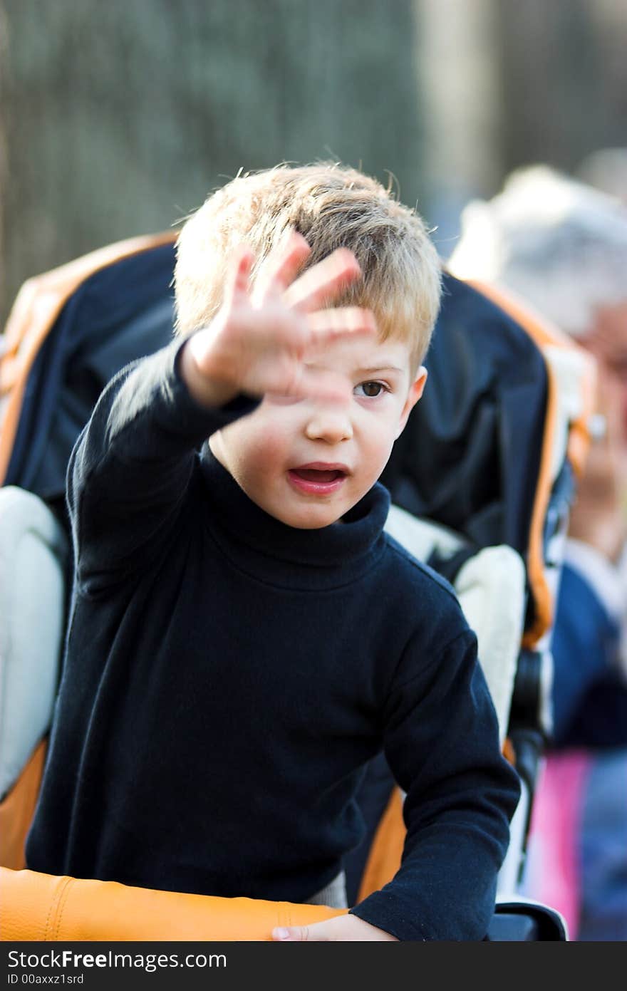 A little boy waving hand