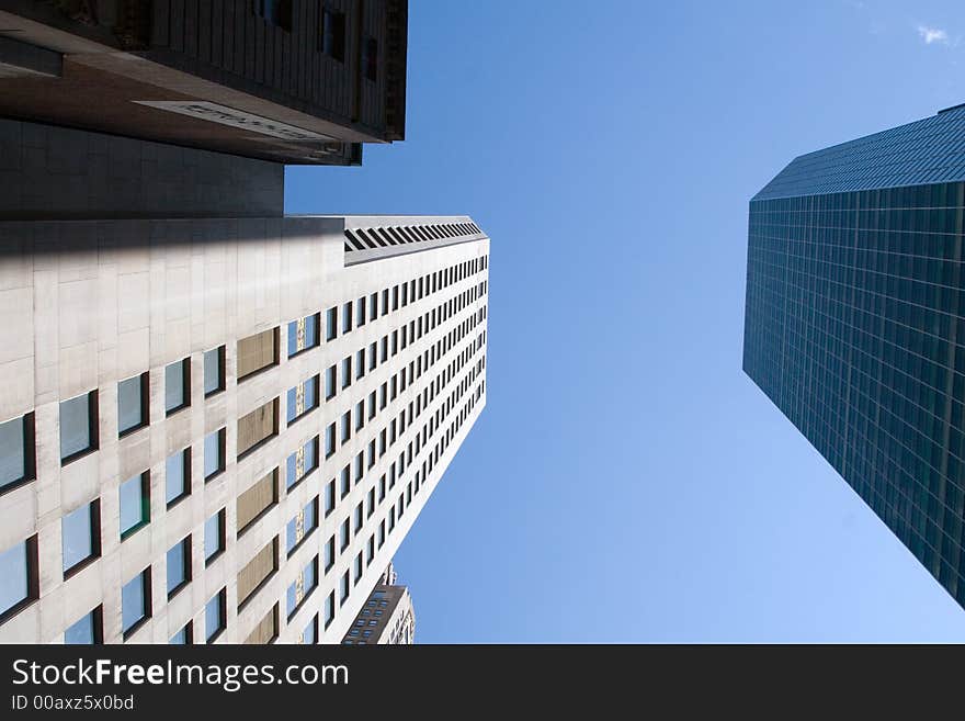 Modern skyscrapers against a bright blue sky