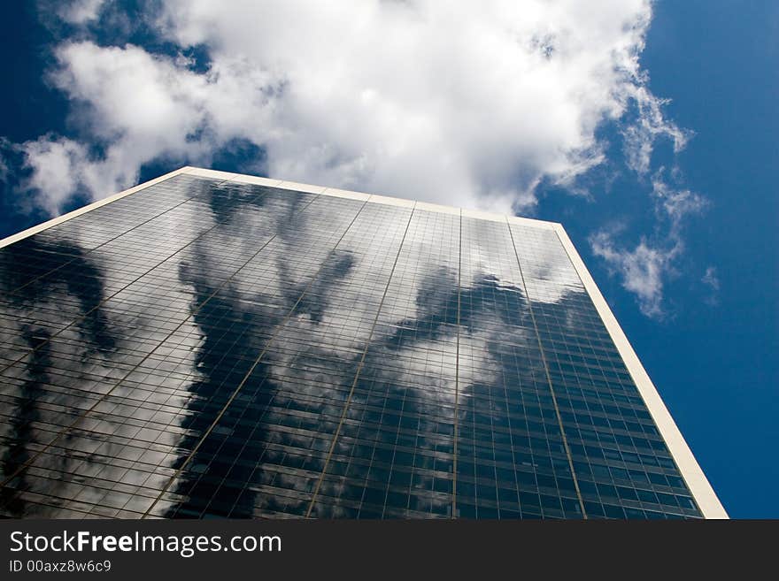 Blue sky reflected in a glass office building. Blue sky reflected in a glass office building