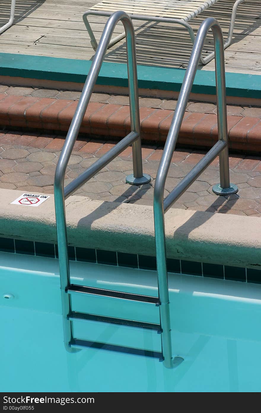 Ladder at edge of outdoor pool. Ladder at edge of outdoor pool