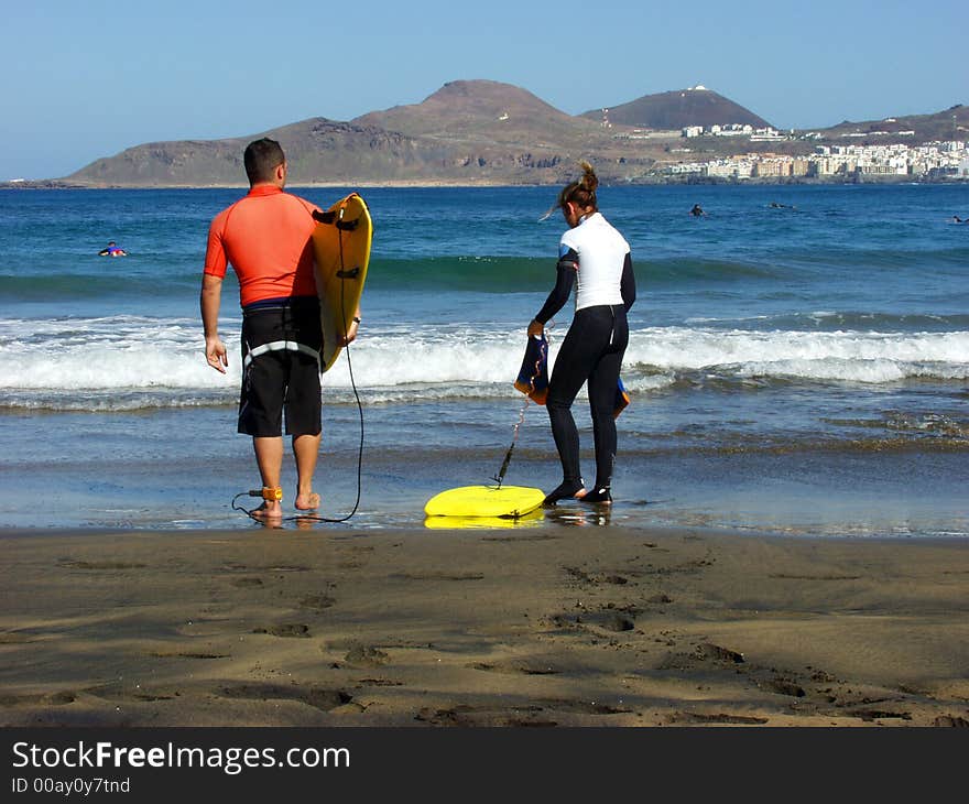 Two young surfers preparing for ride in the weaves