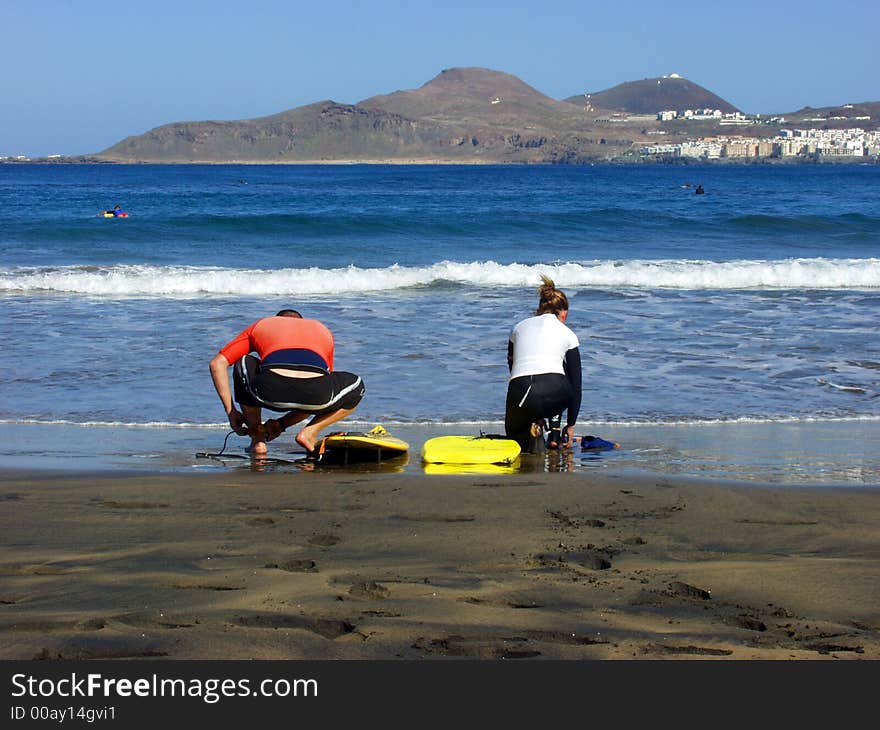 Two young surfers preparing for ride in the weaves