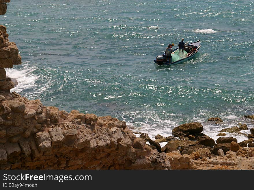 Fishermen in a boat, Cesarea, Israel