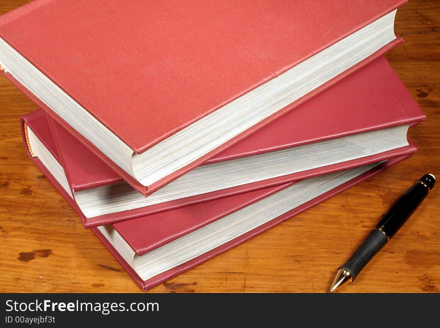 This is an image of books on a desk. This is an image of books on a desk.