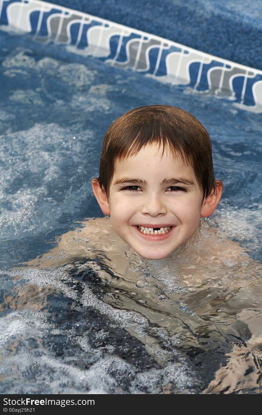 Young boy in pool smiling. Young boy in pool smiling