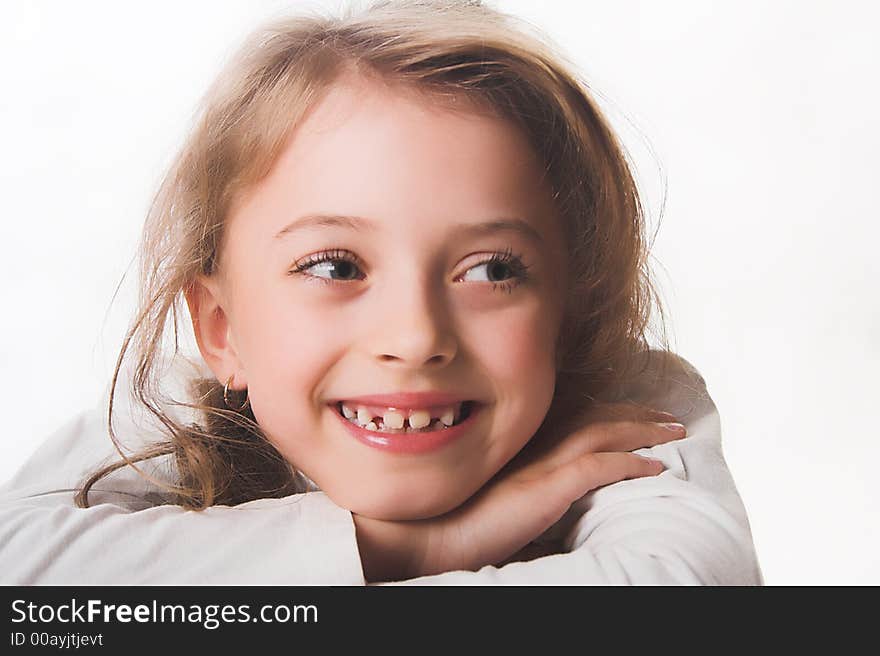 A beautiful blue-eyed, blond child dressed in white.