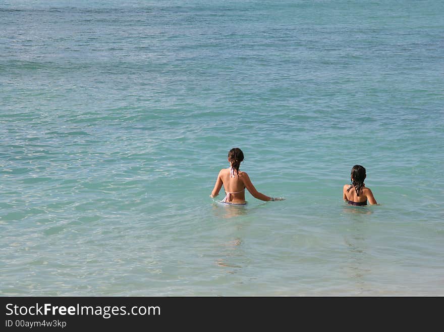 Two girls standing in water. Two girls standing in water