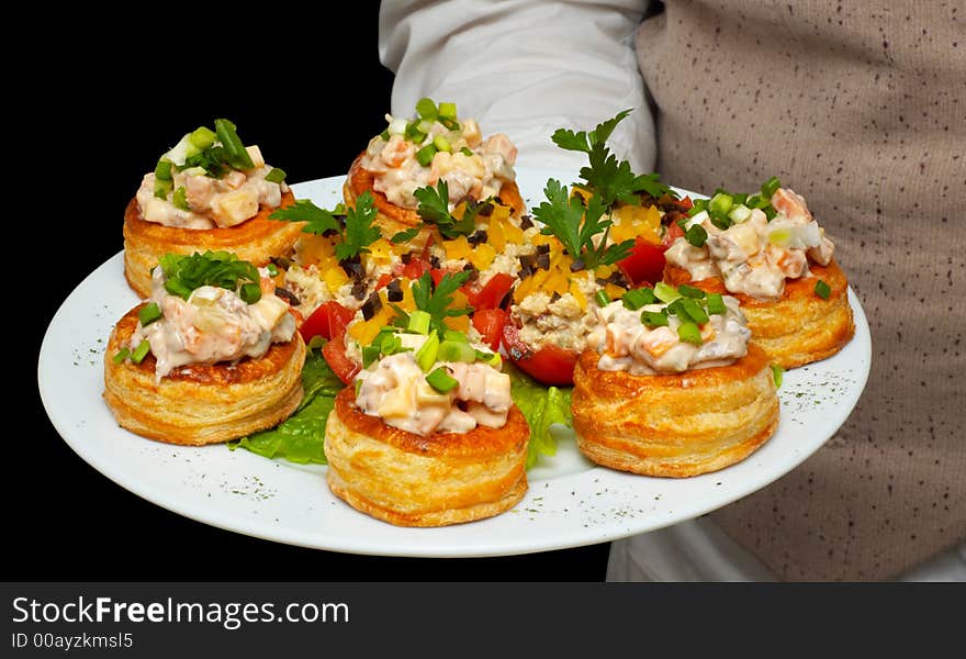 Tartlets with salad on dish