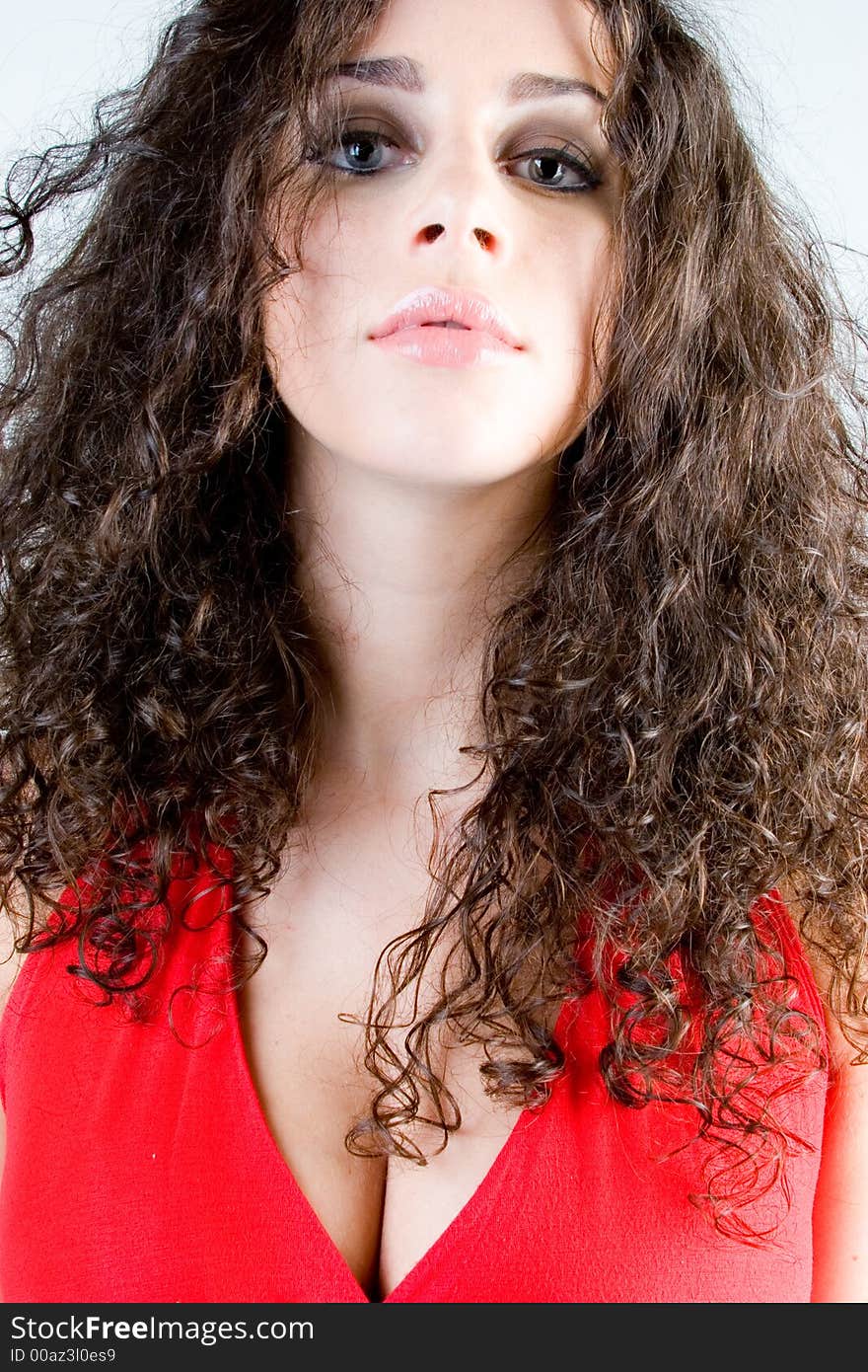 Close up of a beautiful model with curly brunette hair. Perfect for skincare / haircare  beauty / cosmetics advertisement. Close up of a beautiful model with curly brunette hair. Perfect for skincare / haircare  beauty / cosmetics advertisement.