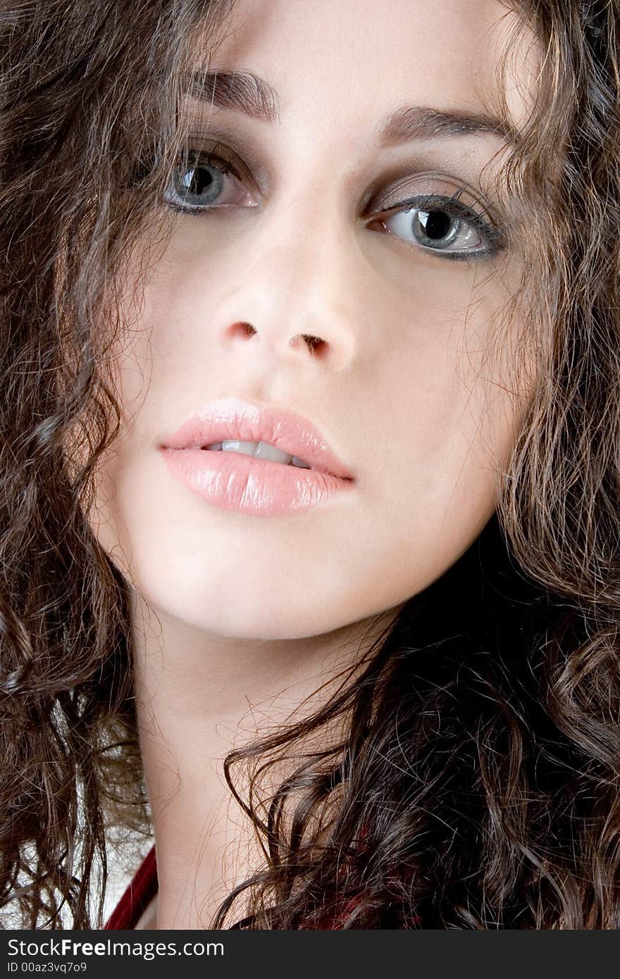 Close up of a beautiful model with curly brunette hair. Perfect for skincare / haircare beauty / cosmetics advertisement. Close up of a beautiful model with curly brunette hair. Perfect for skincare / haircare beauty / cosmetics advertisement.