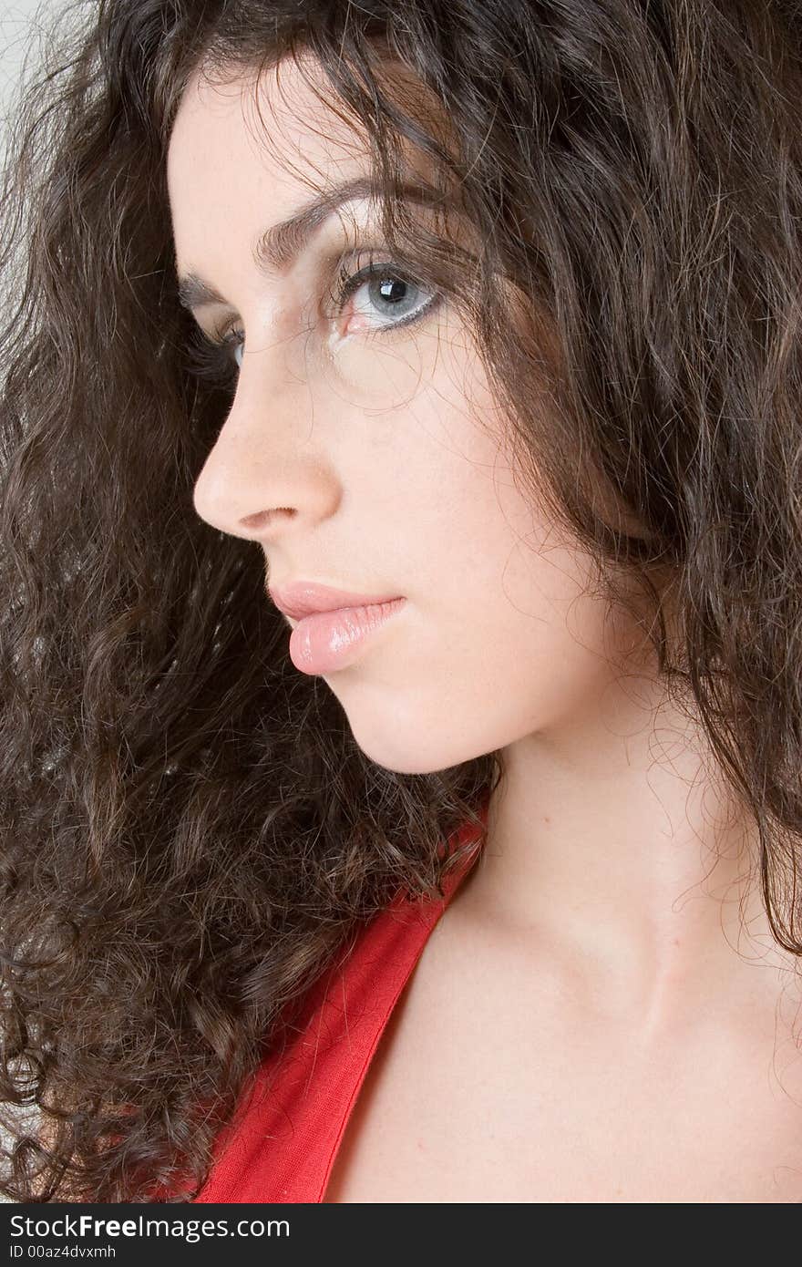 Close up of a beautiful model with curly brunette hair. Perfect for skincare / haircare beauty / cosmetics advertisement. Close up of a beautiful model with curly brunette hair. Perfect for skincare / haircare beauty / cosmetics advertisement.