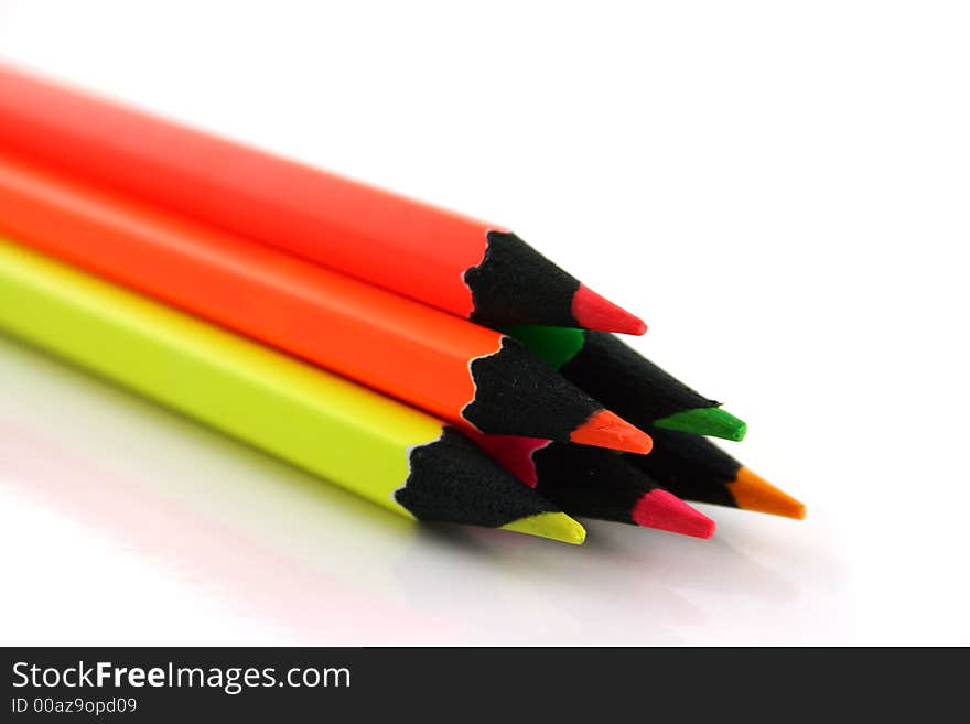 Pyramid of 6 neon pencils on a white background