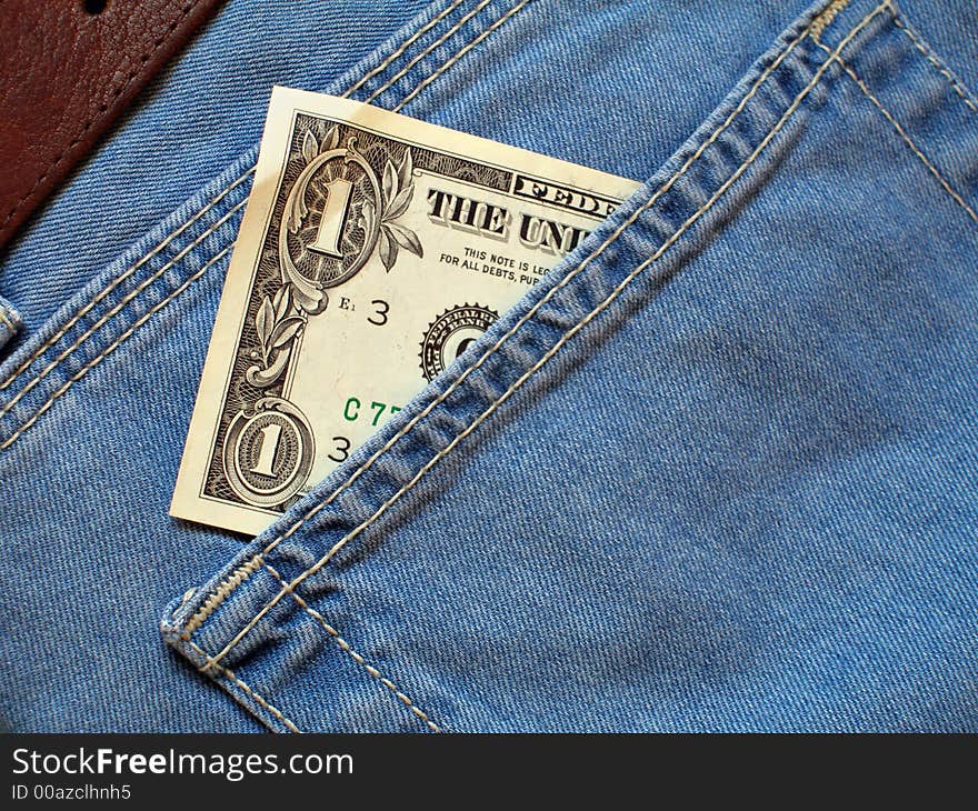 One dollar bill within back pocket of jeans