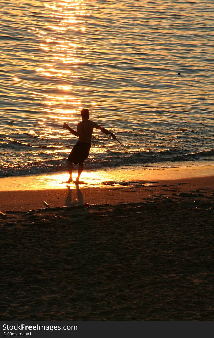 Playing Racket Ball at a beach Sunset. Playing Racket Ball at a beach Sunset