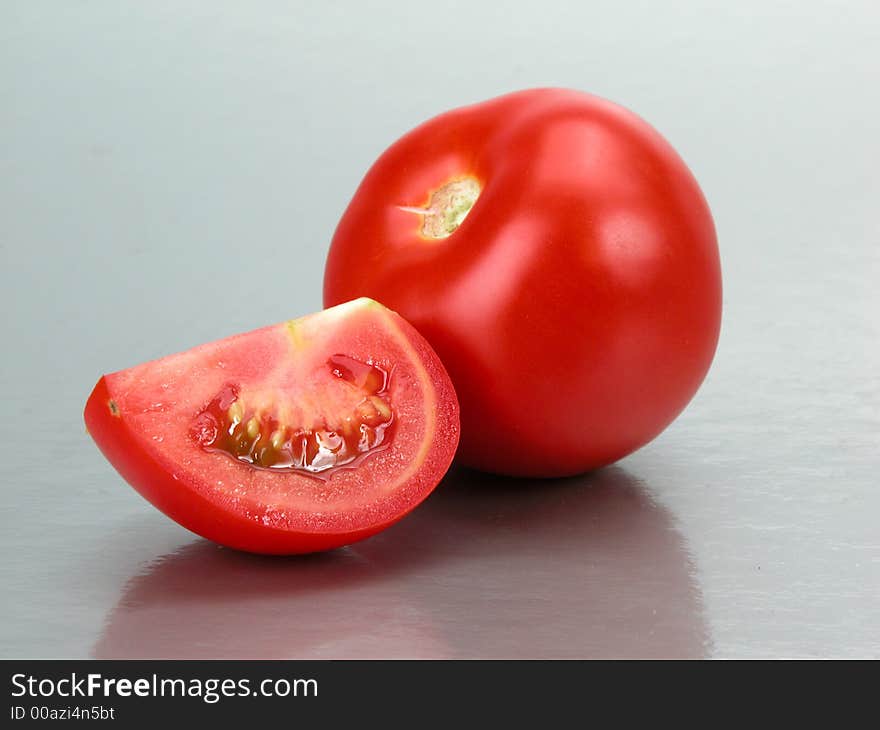 Some tomatoes on a grey background. Some tomatoes on a grey background