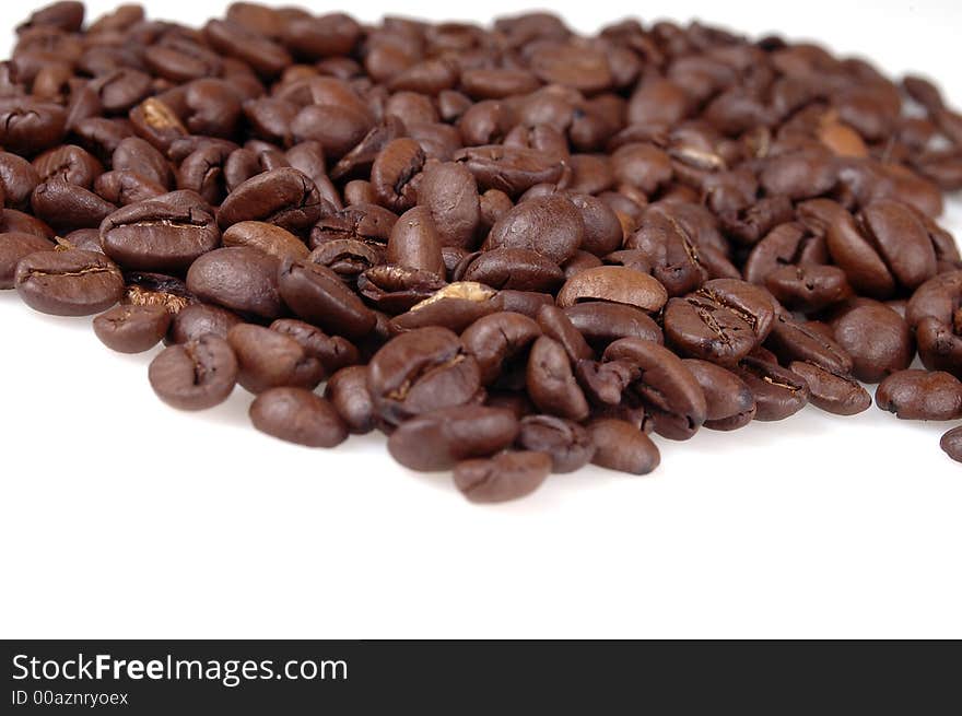 A pile of coffee beans against a white background. A pile of coffee beans against a white background.