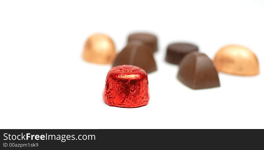 Fancy tasty chocolates over white background with selective focus. Fancy tasty chocolates over white background with selective focus.