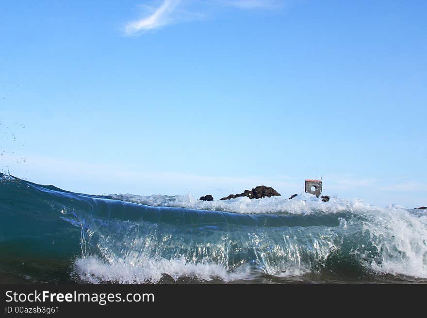 Partial view of a wave and a small church in the bay of San Agustinillo in the southern state of Oaxaca in  Mexico, Latin America. Partial view of a wave and a small church in the bay of San Agustinillo in the southern state of Oaxaca in  Mexico, Latin America