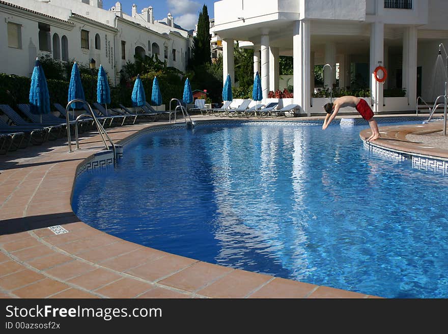 Person diving into a swimming pool