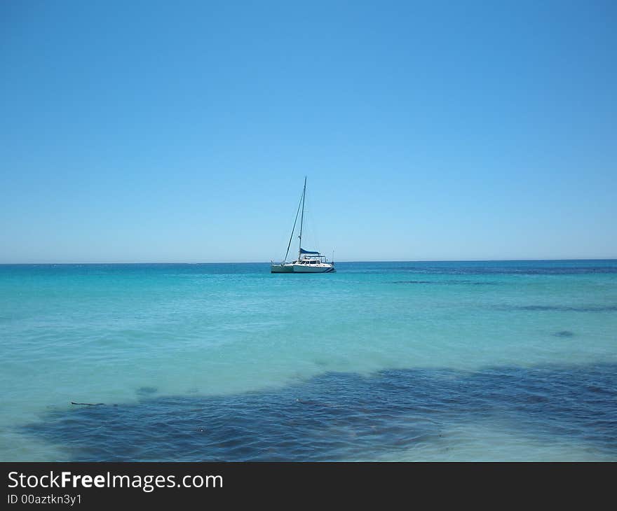 A catamaran yacht, offshore at Sandy Bay, Cape Town, South Africa. A catamaran yacht, offshore at Sandy Bay, Cape Town, South Africa