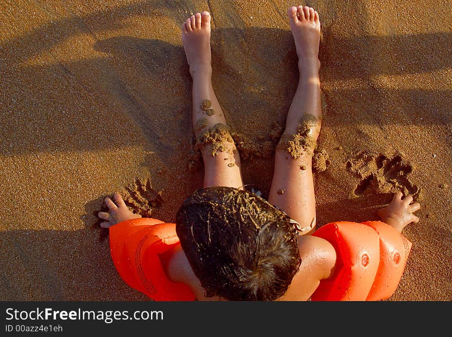 Boy watching the sea siiting at the beach of San Agustinillo in the southern state of Oaxaca in Mexico, Latinamerica