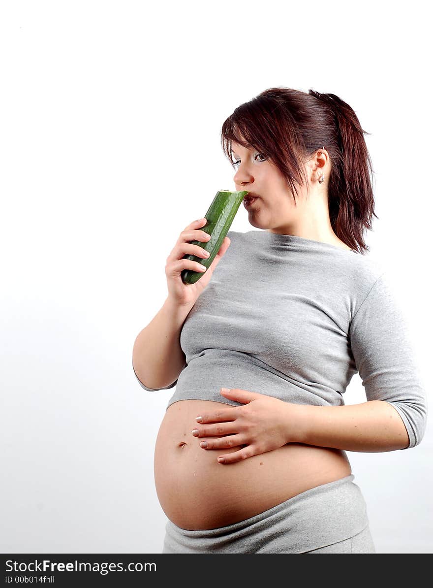 Attractive pregnant woman with cucumber on white background. Attractive pregnant woman with cucumber on white background