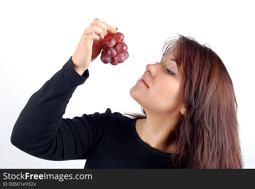 Attractive woman tasting grapes on white background. Attractive woman tasting grapes on white background