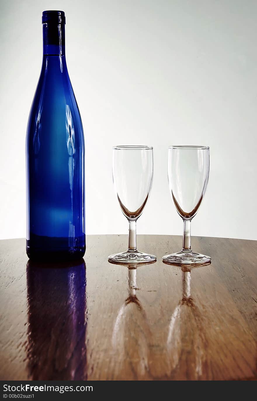 Blue wine bottle with glasses