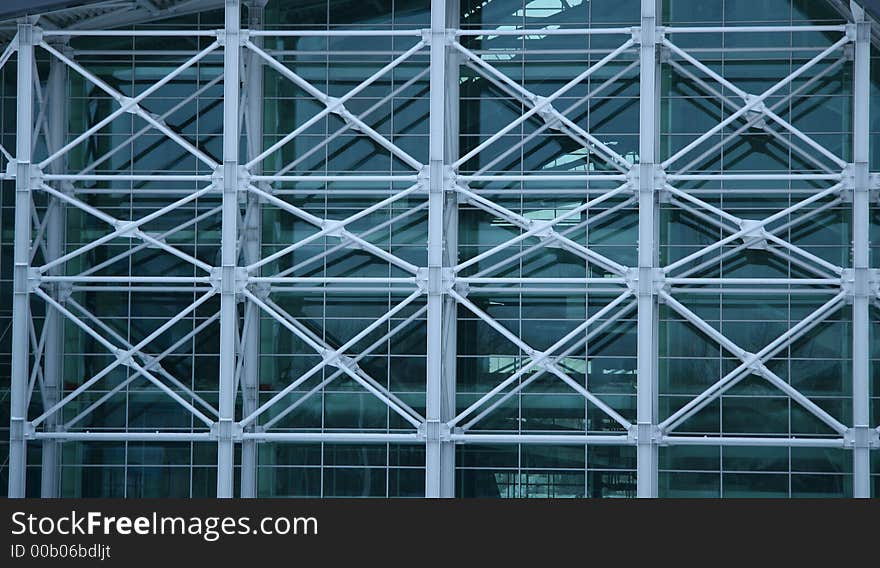 Metal design from crossed grey pipes on a facade of a building. Metal design from crossed grey pipes on a facade of a building.