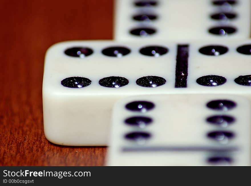 Detailed macro close up shot of a set of dominos. Setup correctly with the double 6 as a starting point issuing the game at hand.