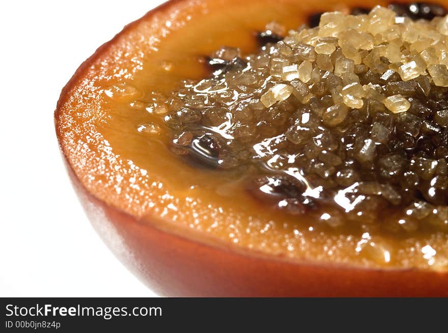 Tropical fruit tamarillo with brown sugar, isolated on white