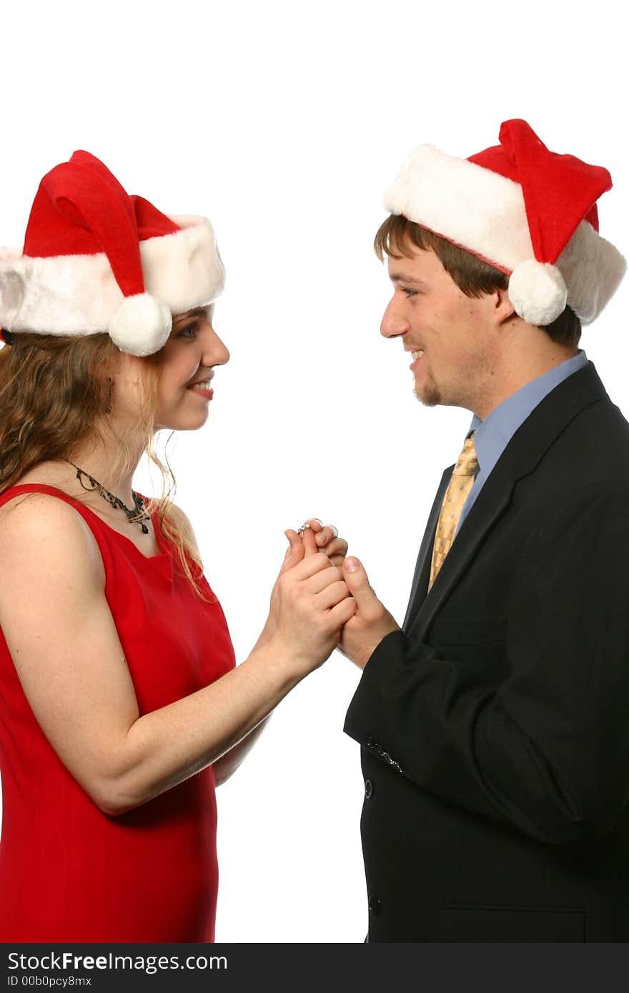 Young couple wearing Santa hats at Christmas. Young couple wearing Santa hats at Christmas