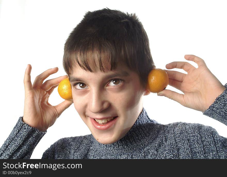 The boy and two mandarines. The boy and two mandarines