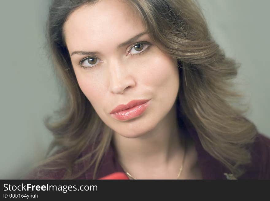 Pretty young lady looking straight at the camera. Shoulder portrait.