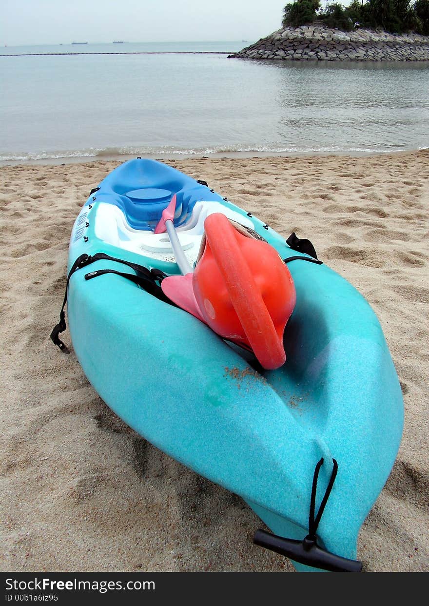 A kayak canoe on a deserted beach. A kayak canoe on a deserted beach.