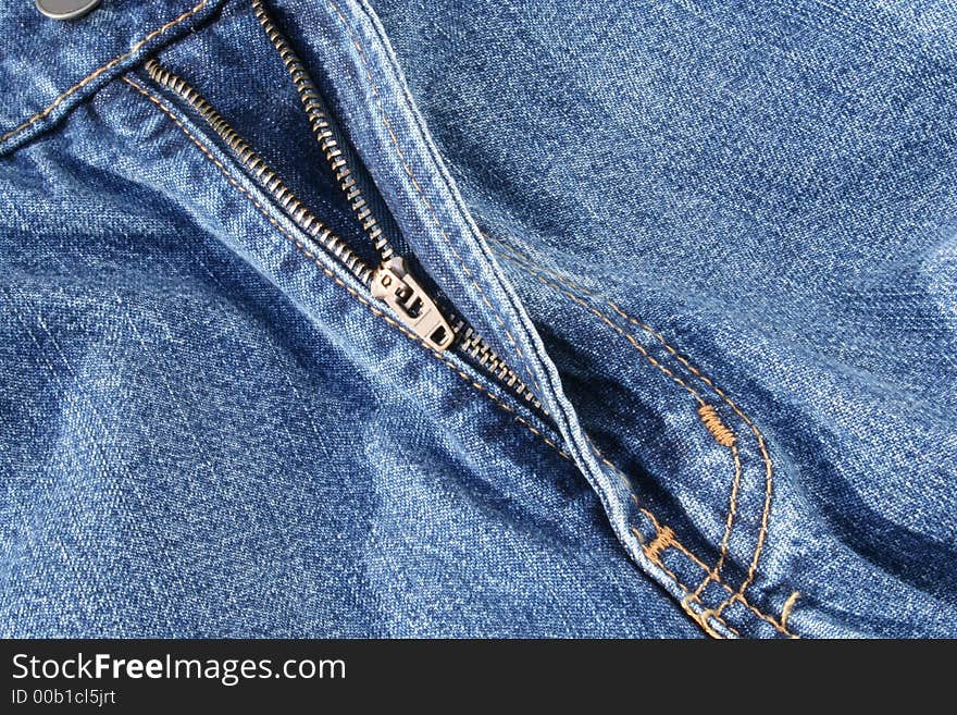 The Open Zipper of a Pair of Jeans is Featured. The Open Zipper of a Pair of Jeans is Featured.