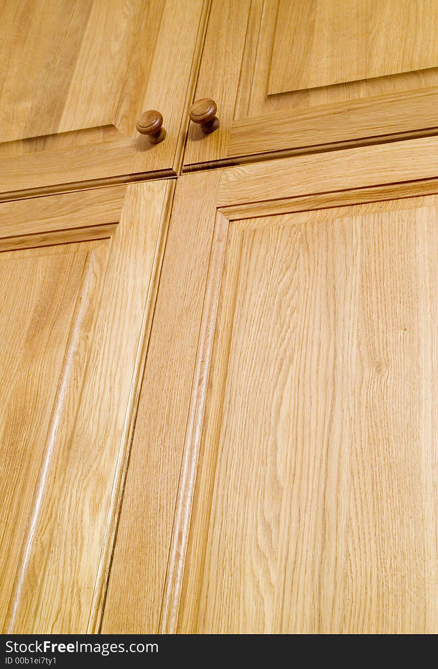 Wooden oak wardrobe door two handles closeup. Wooden oak wardrobe door two handles closeup