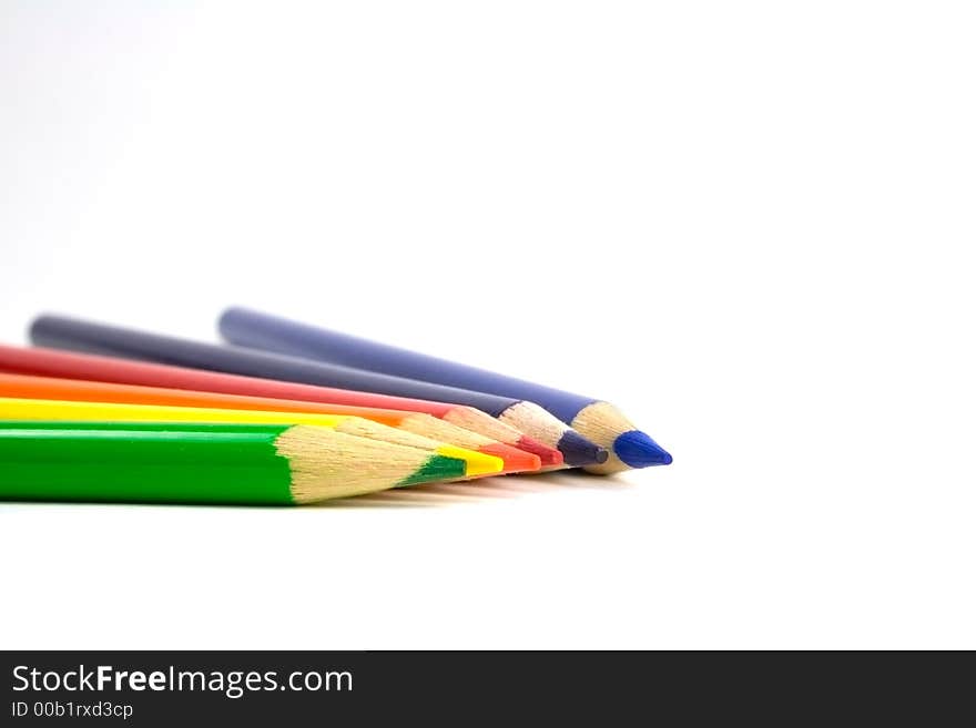 Six colored pencils on a white background