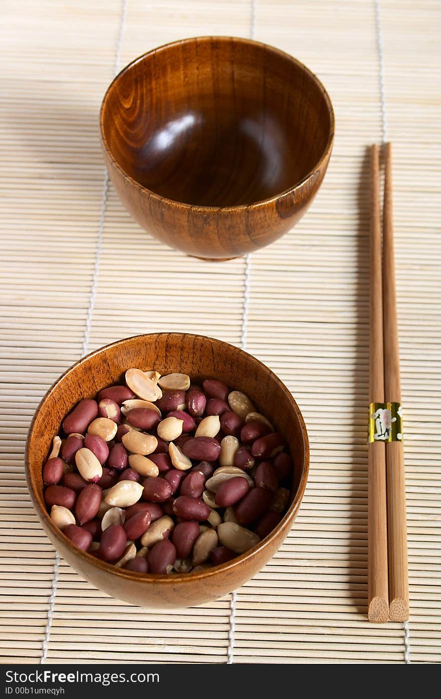 Bamboo dish with peanuts on the mat, shallow DOF