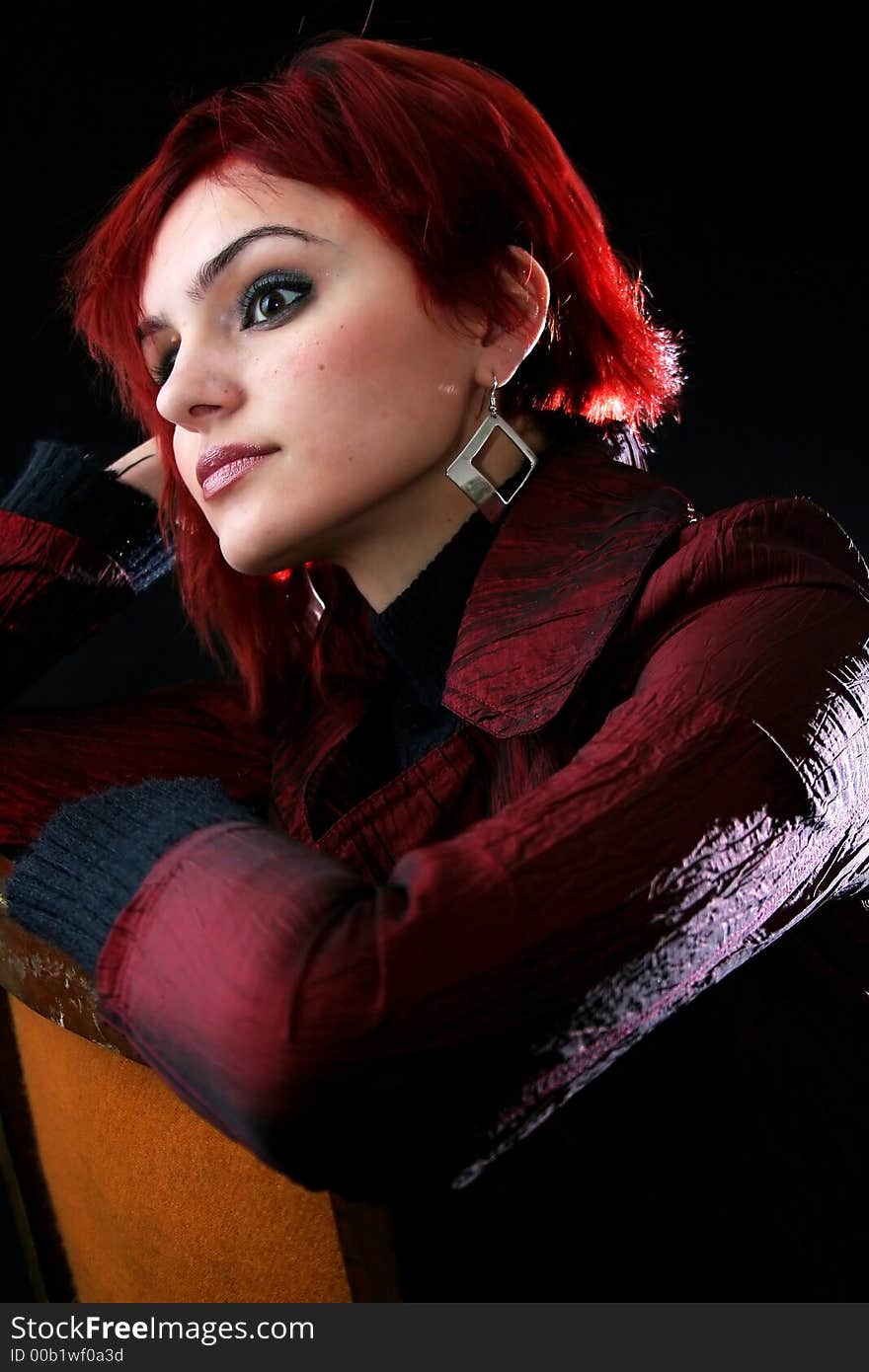 Young woman with red hair thinking, black background. Young woman with red hair thinking, black background