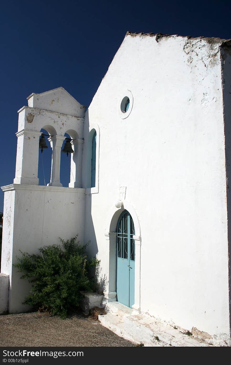 White greek church with campanile and two bells