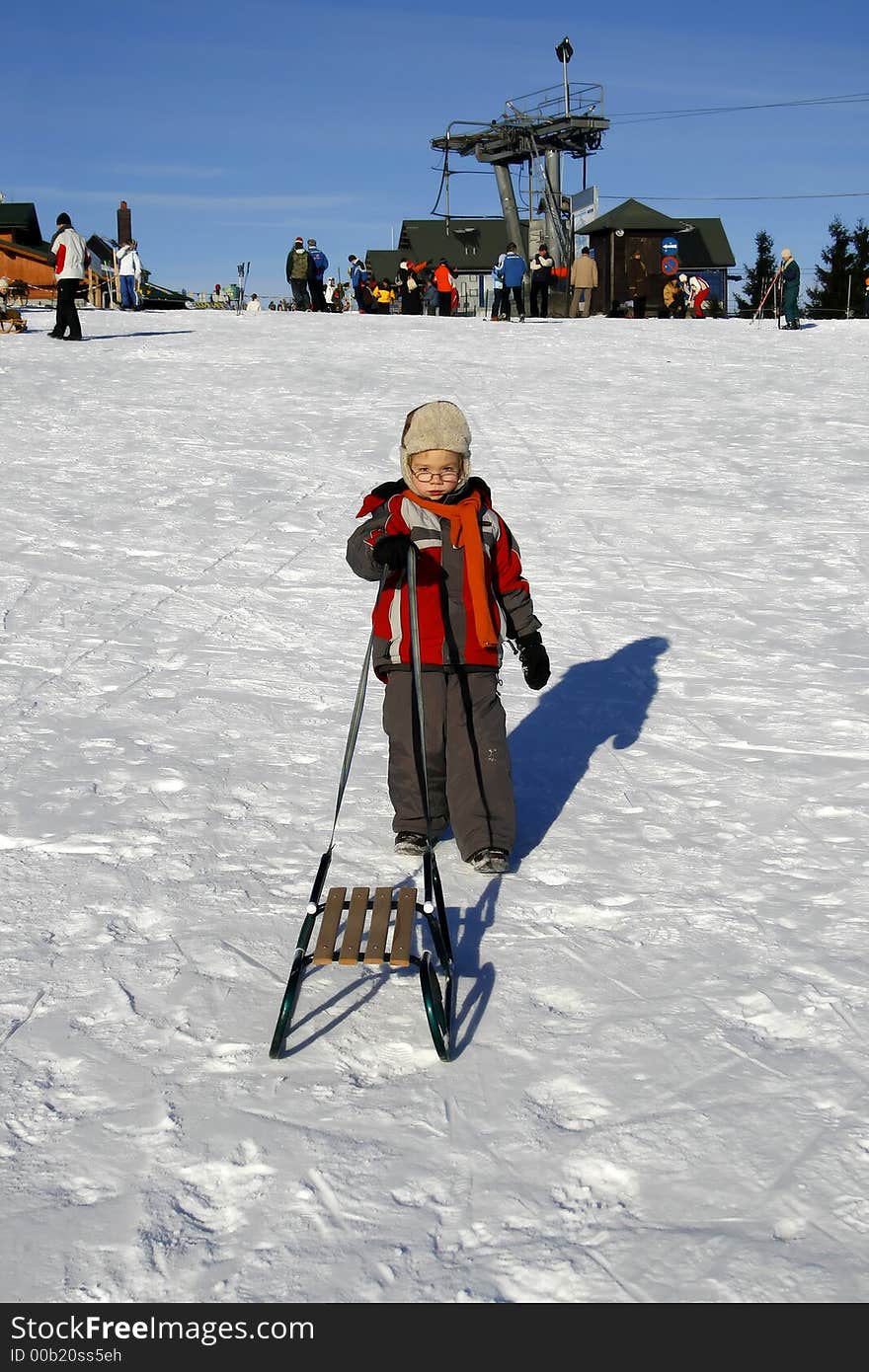 Boy with sled in winter time