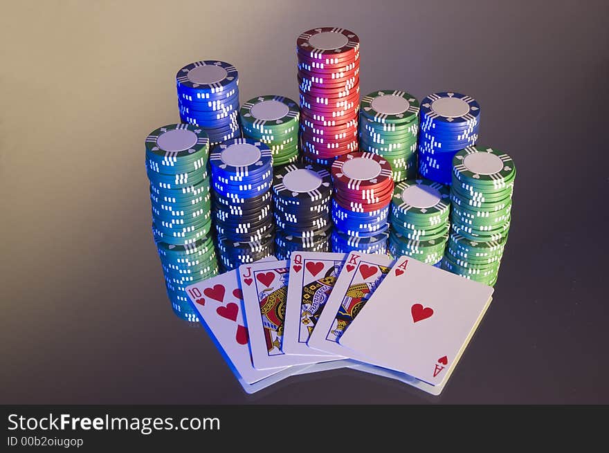 Royal Flush, hearts, with poker chips, left hand blue lighting on mirror.